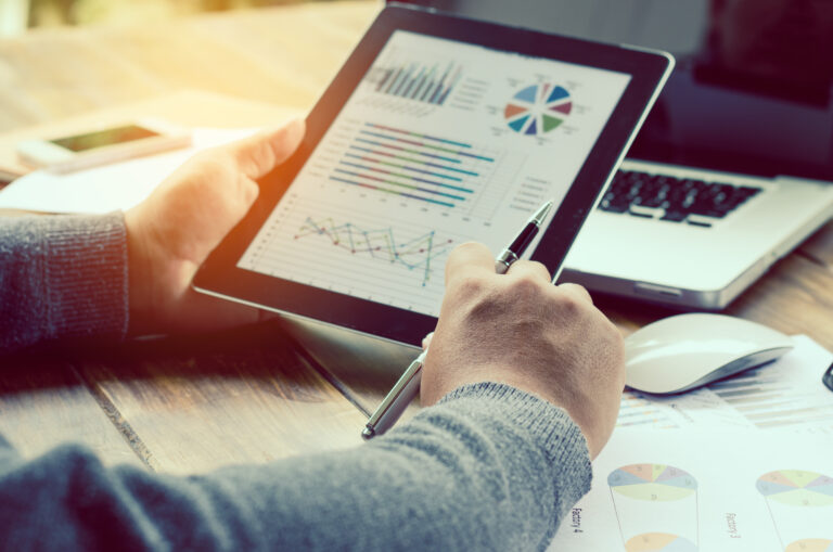cropped-hands-businessman-using-digital-tablet-desk